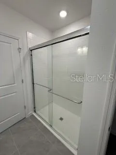 a bathroom with a glass shower door