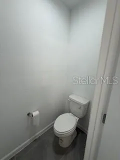 a white toilet sitting next to a shower