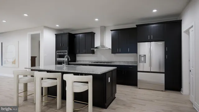 a kitchen with stainless steel appliances granite countertop a refrigerator and a stove