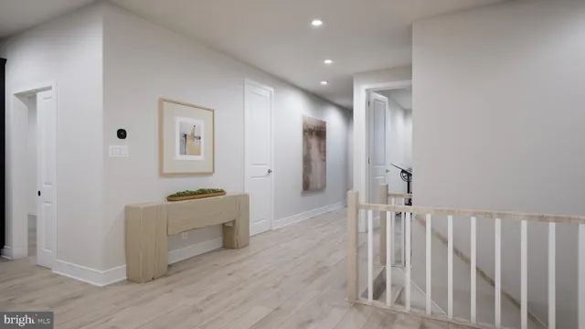 a view of hallway with wooden floor