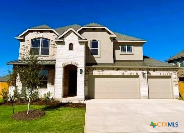 a front view of a house with a yard