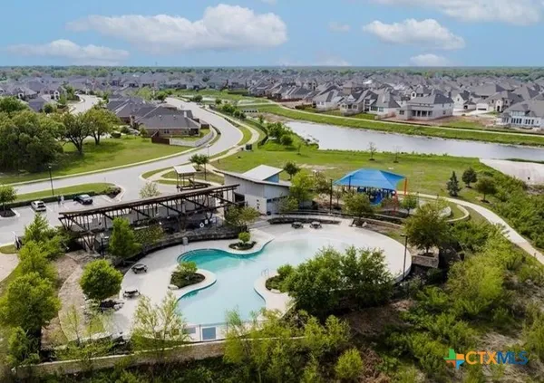 a view of empty room with wooden floor and fence