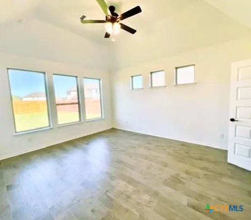 a spacious bathroom with a tub sink and mirror