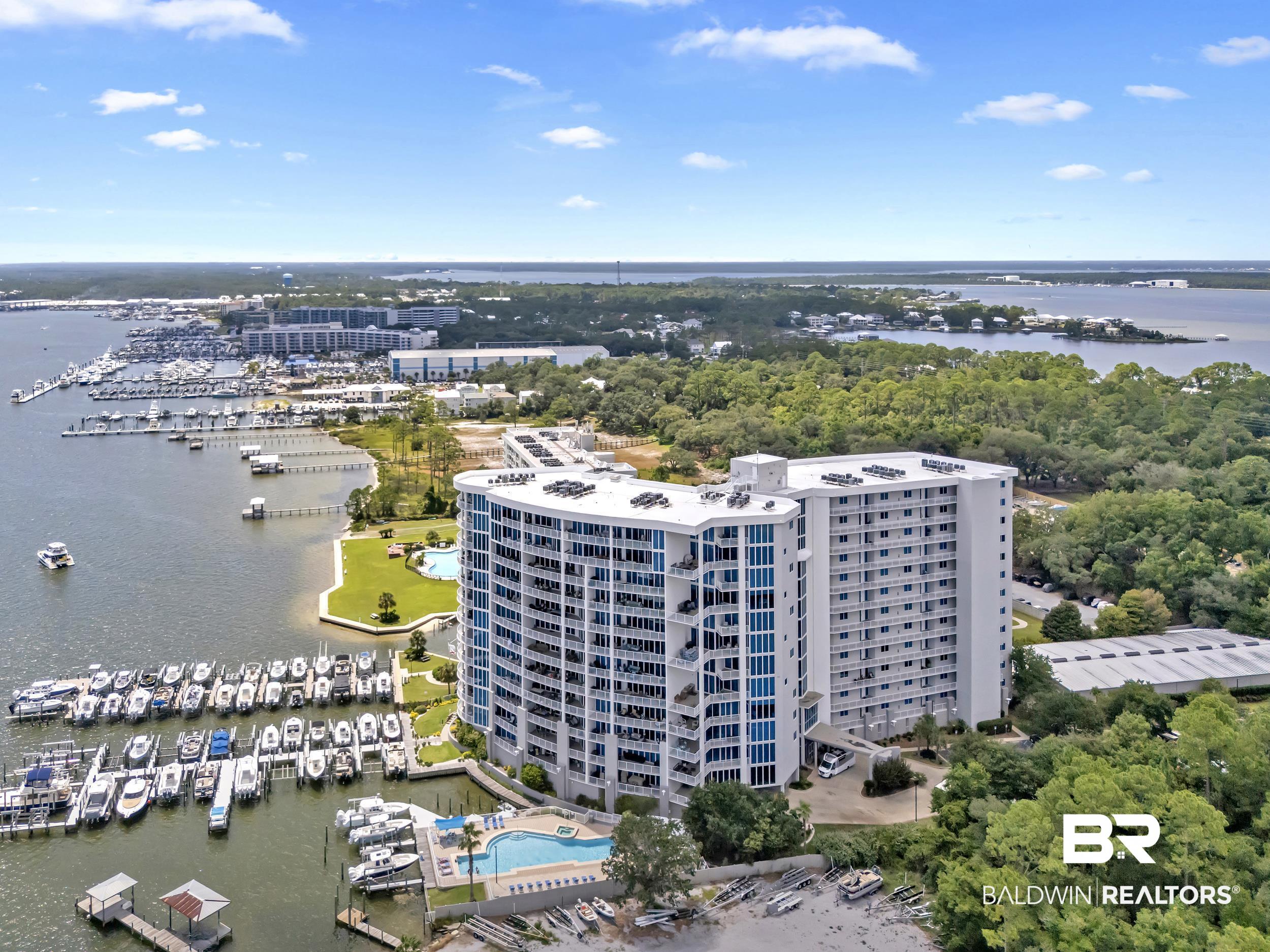 28250 Canal Road, Unit 307 Orange Beach, AL 36561 - Photo 7 of 56 Bird's eye view of a nearby body of water and numerous boat docks