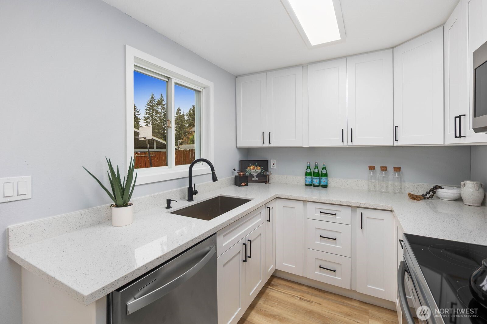 505 Southwest 305th Street Federal Way, WA 98023 - Photo 11 of 38 a kitchen with white cabinets and sink