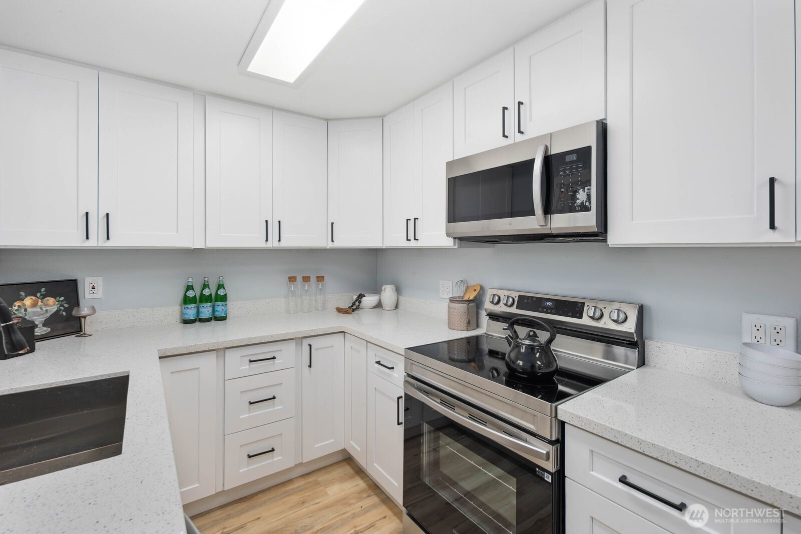 505 Southwest 305th Street Federal Way, WA 98023 - Photo 13 of 38 a kitchen with cabinets appliances and a sink
