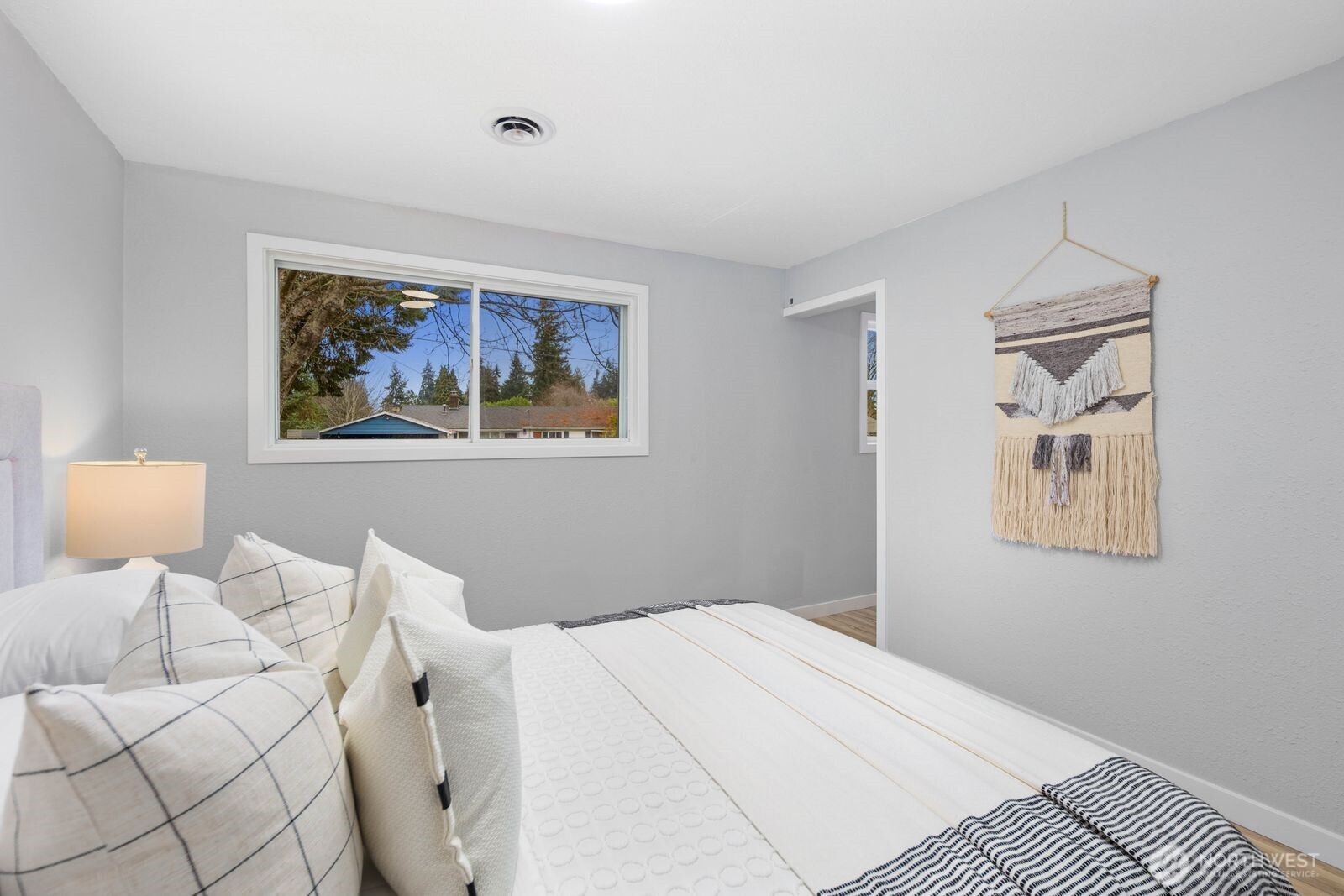 505 Southwest 305th Street Federal Way, WA 98023 - Photo 15 of 38 a bedroom with a bed and a painting on the wall
