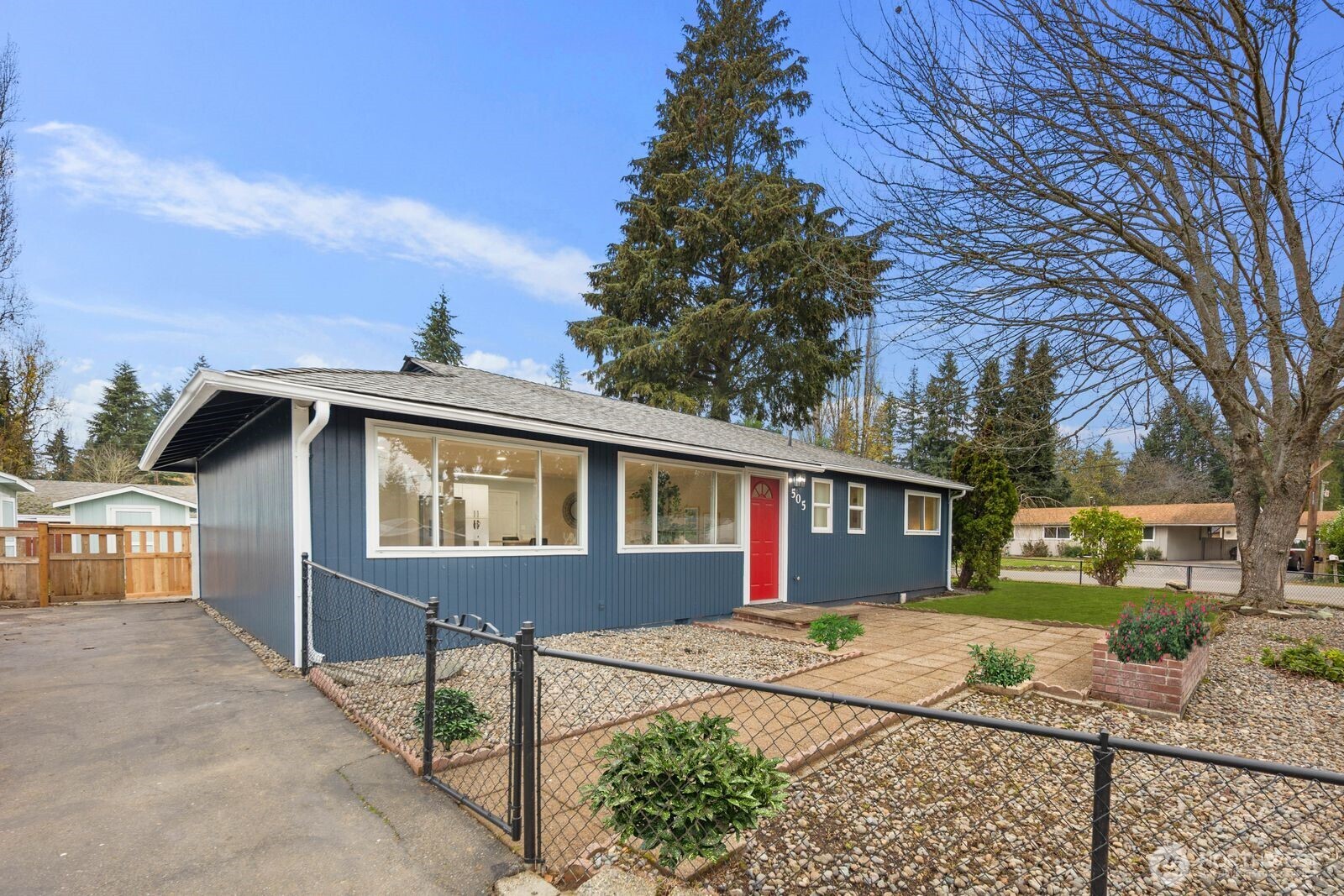 505 Southwest 305th Street Federal Way, WA 98023 - Photo 2 of 38 a front view of a house with a yard and potted plants