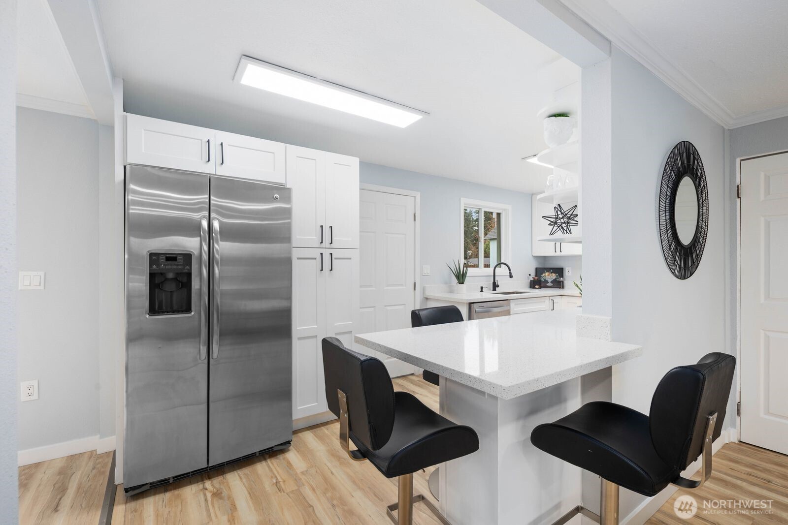 505 Southwest 305th Street Federal Way, WA 98023 - Photo 10 of 38 a kitchen with stainless steel appliances granite countertop a sink refrigerator and cabinets
