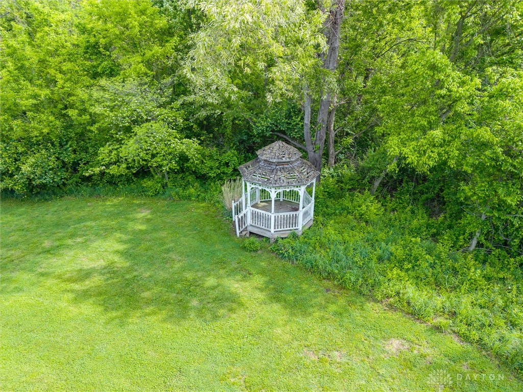 2165 Stewart Road Xenia, OH 45385 - Photo 45 of 59 This outdoor space offers a charming gazebo nestled among lush greenery, providing a tranquil retreat.
