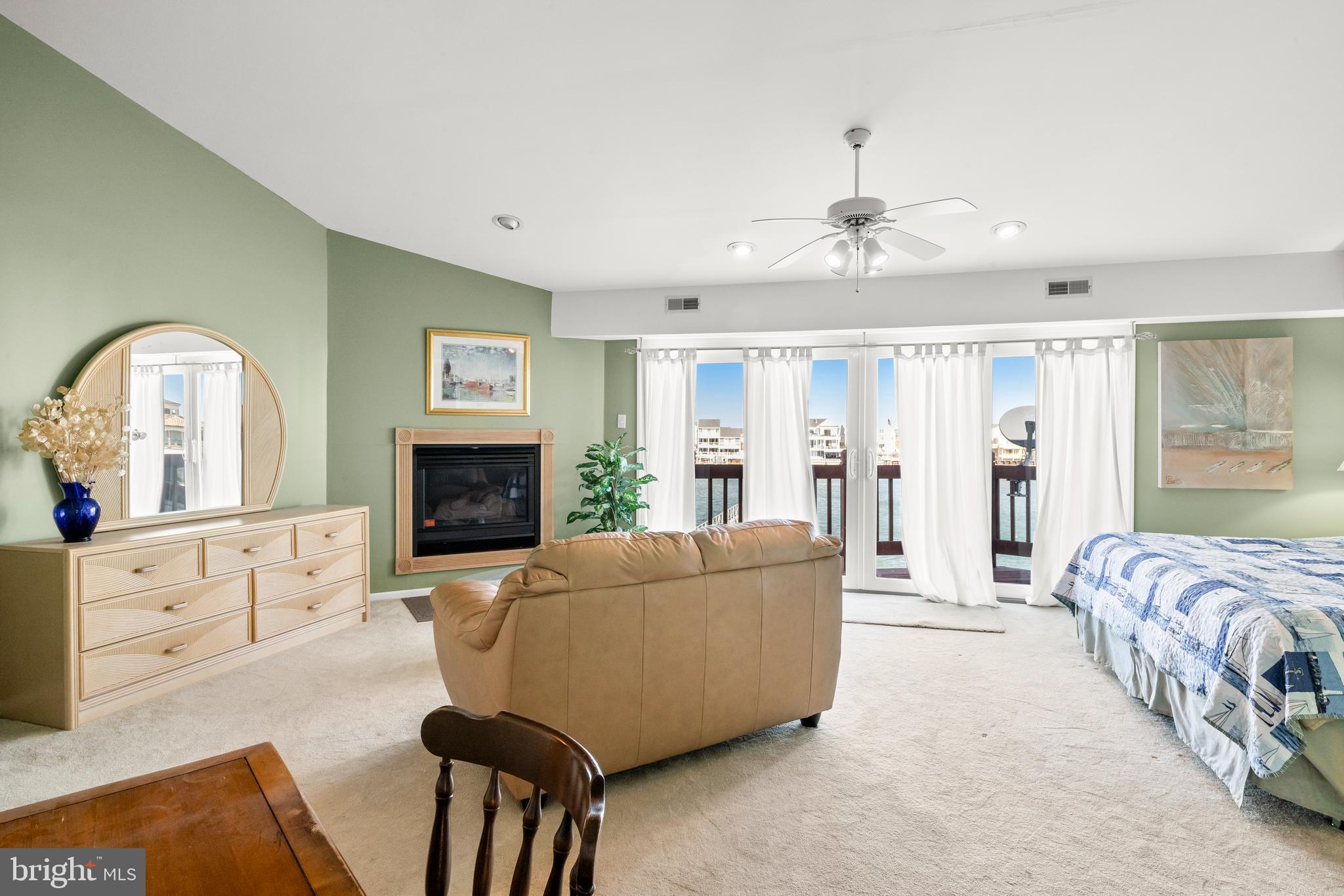 313 Gull Cove Brigantine, NJ 08203 - Photo 21 of 34 a living room with furniture a fireplace and a flat screen tv