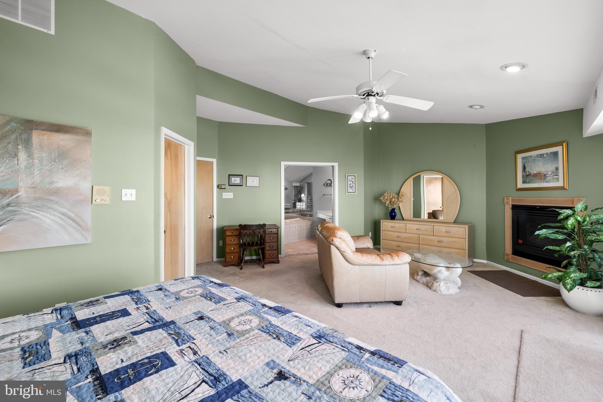 313 Gull Cove Brigantine, NJ 08203 - Photo 24 of 34 a bedroom with a bed and a chandelier
