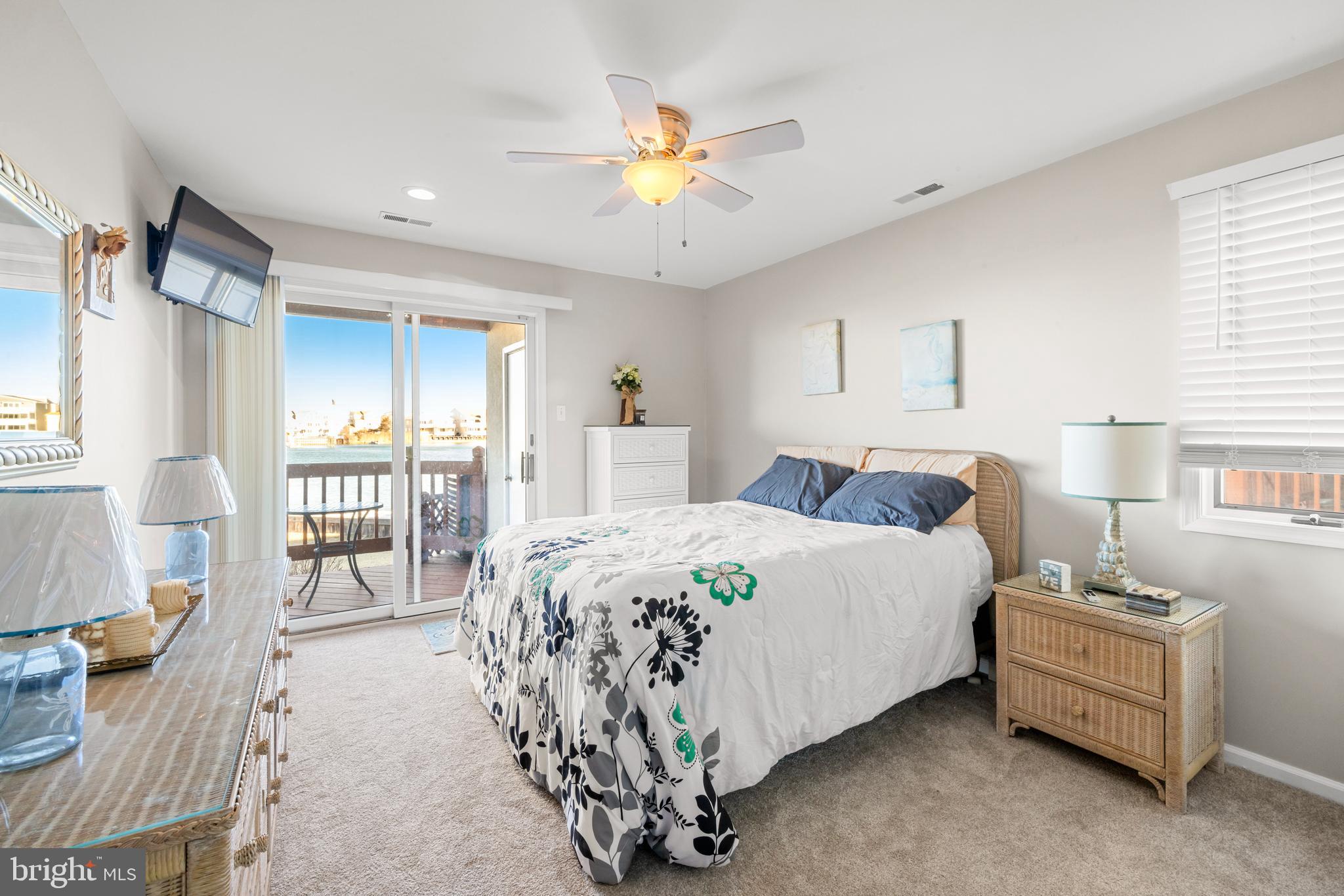 313 Gull Cove Brigantine, NJ 08203 - Photo 7 of 34 a spacious bedroom with a bed and a chandelier