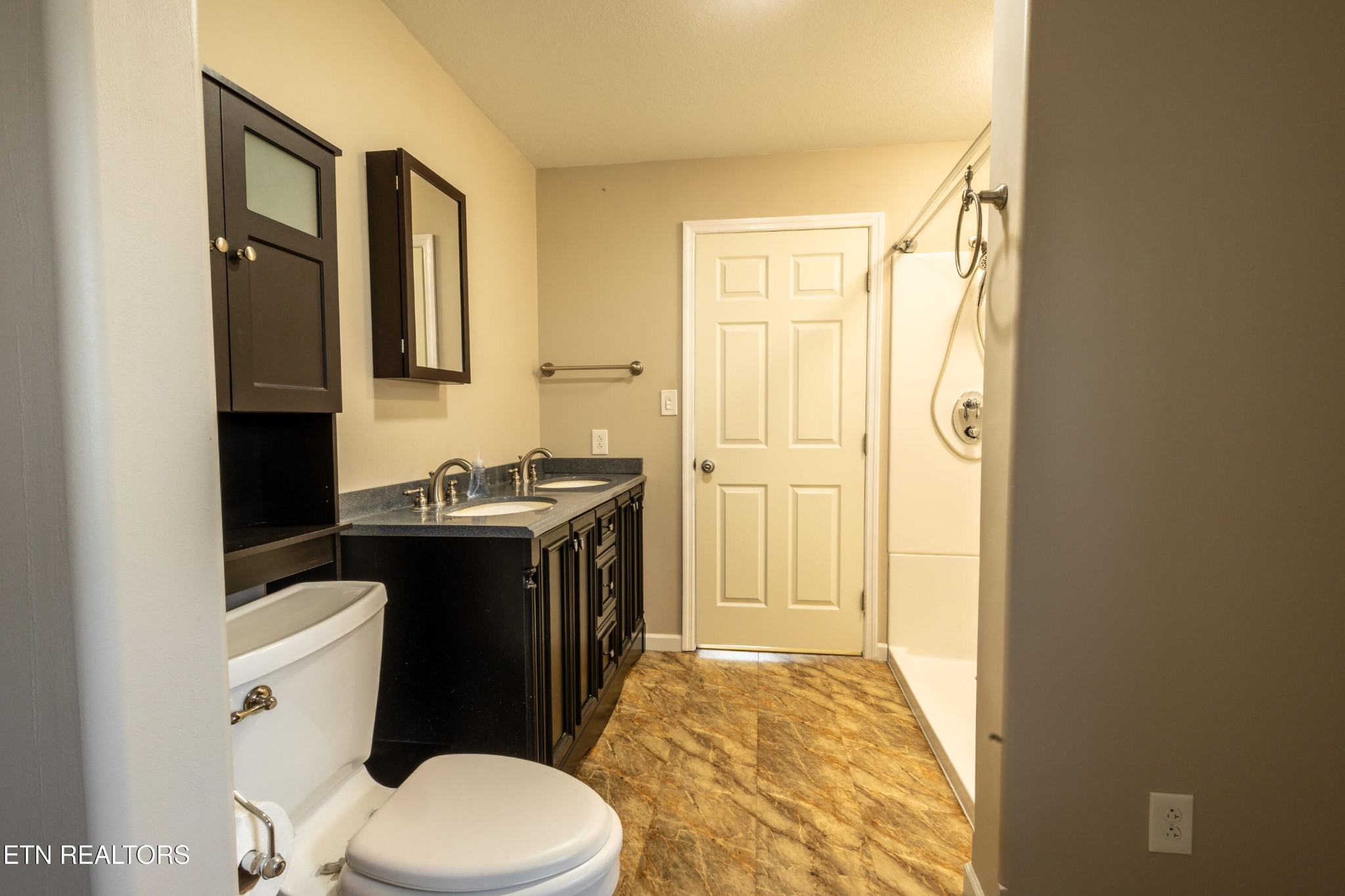 1208 Dutch Valley Road Clinton, TN 37716 - Photo 9 of 21 a bathroom with a sink a toilet a mirror and vanity