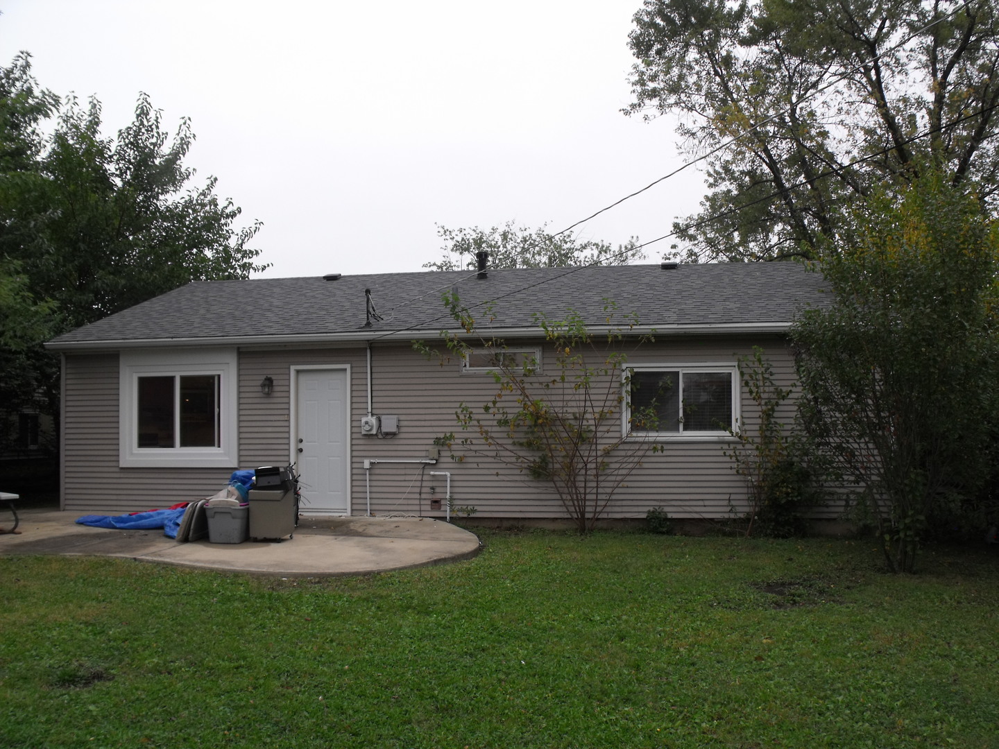 419 Tallman Avenue Romeoville, IL 60446 - Photo 2 of 10 a view of a backyard with table and chairs potted plants and large tree