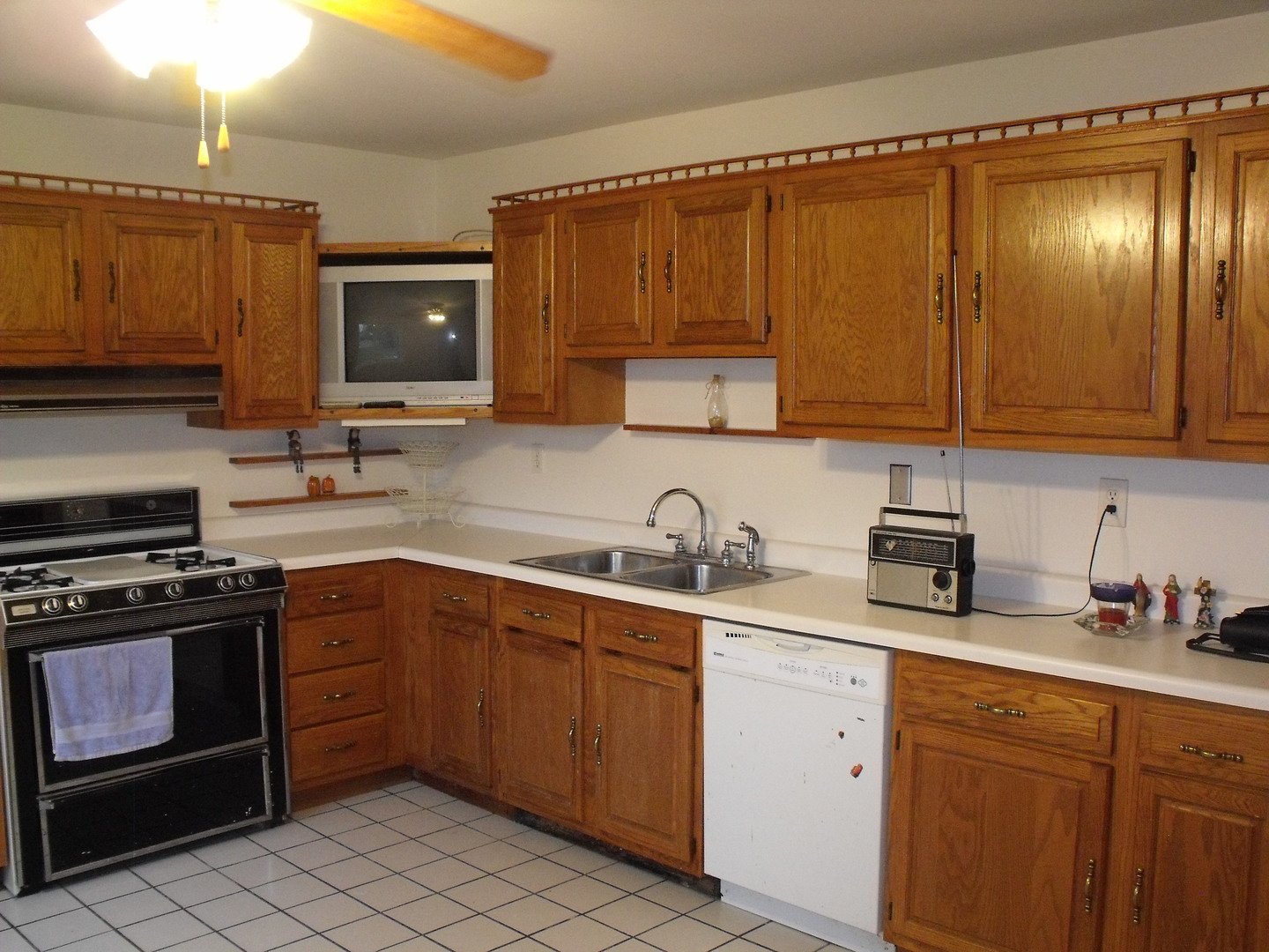 419 Tallman Avenue Romeoville, IL 60446 - Photo 4 of 10 a kitchen with a sink stove top oven and cabinets