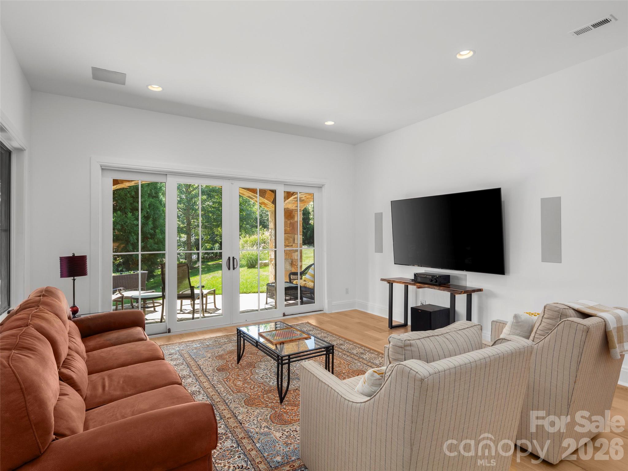 4 Windelsham Way Arden, NC 28704 - Photo 27 of 46 a living room with furniture a flat screen tv and a large window