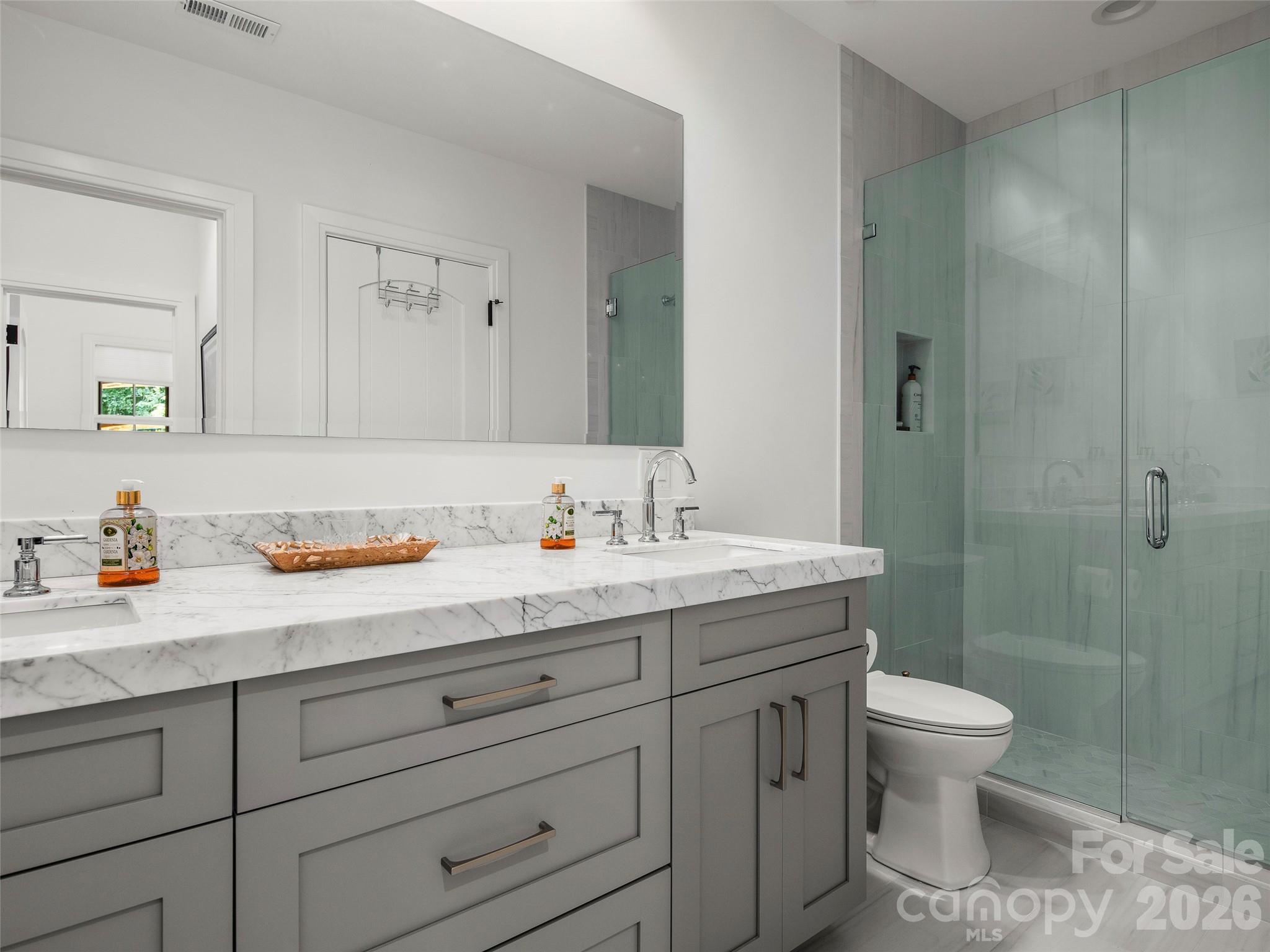 4 Windelsham Way Arden, NC 28704 - Photo 34 of 46 a bathroom with a granite countertop sink a toilet and a shower
