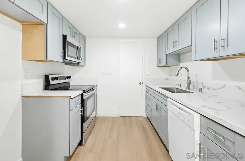 637 R Avenue, Unit 37 National City, CA 91950 - Photo 11 of 27 a kitchen with stainless steel appliances a sink stove and cabinets