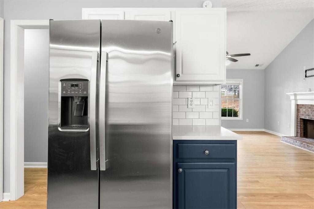 1022 Miss Amber Way Locust Grove, GA 30248 - Photo 13 of 43 a kitchen with a refrigerator and white cabinets