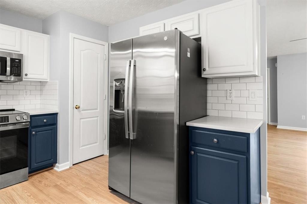 1022 Miss Amber Way Locust Grove, GA 30248 - Photo 14 of 43 a kitchen with a refrigerator and a sink