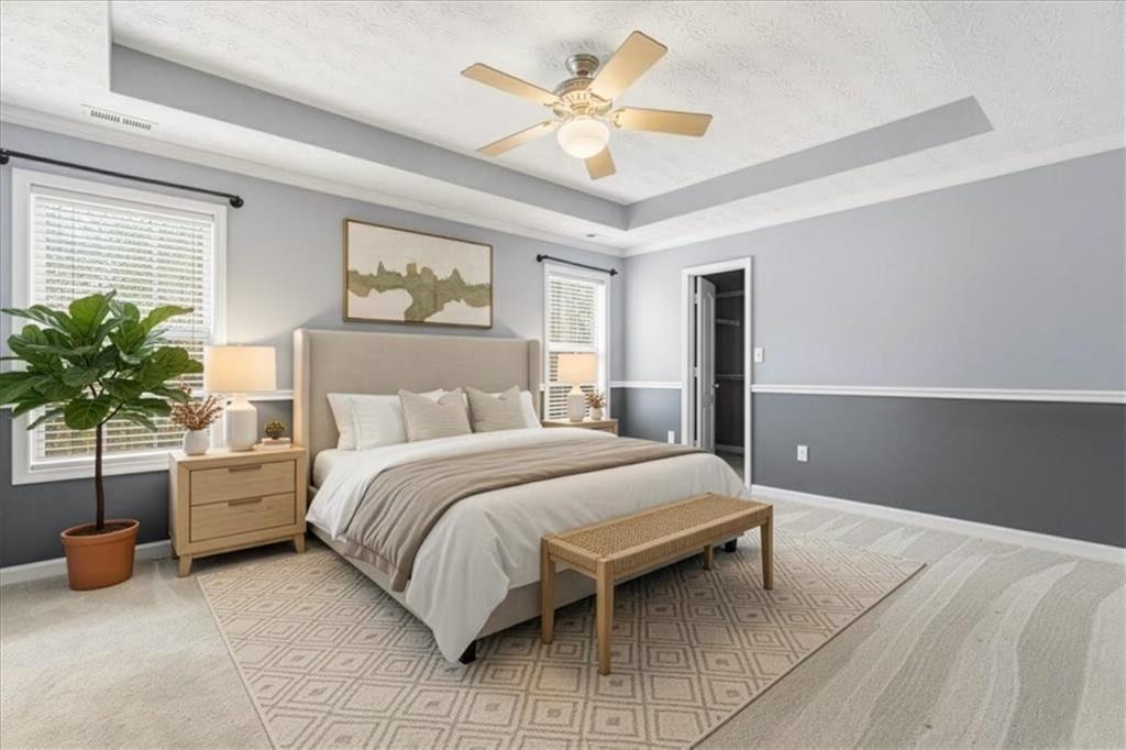 1022 Miss Amber Way Locust Grove, GA 30248 - Photo 15 of 43 a bedroom with a bed and a chandelier