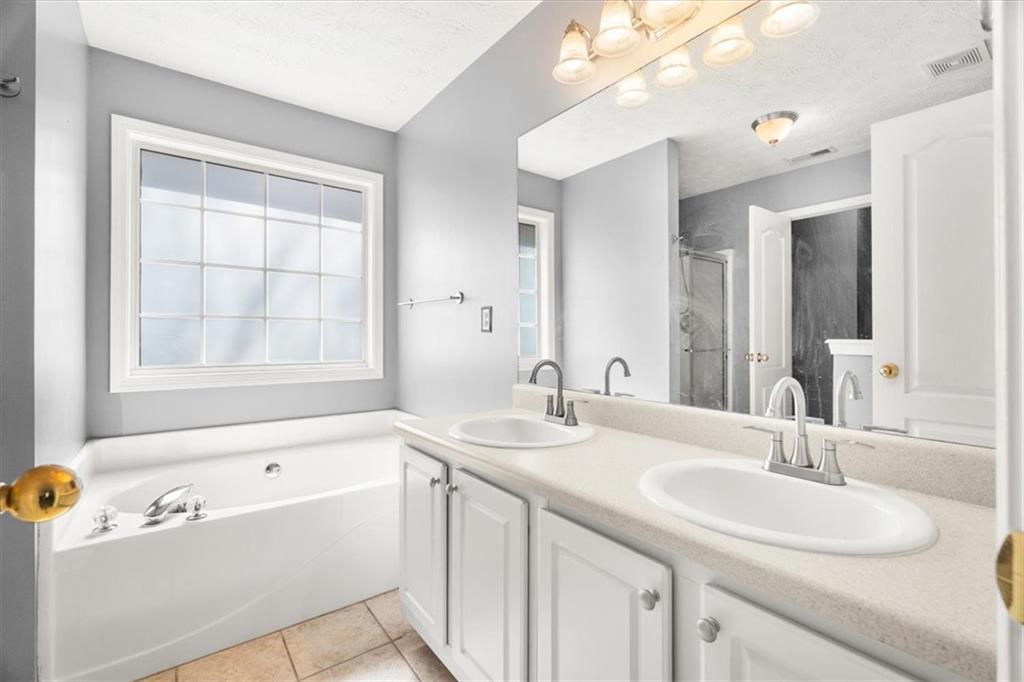 1022 Miss Amber Way Locust Grove, GA 30248 - Photo 18 of 43 a bathroom with a sink and a bathtub