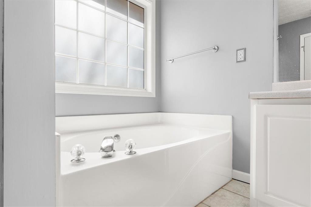 1022 Miss Amber Way Locust Grove, GA 30248 - Photo 20 of 43 a white bath tub sitting next to a window