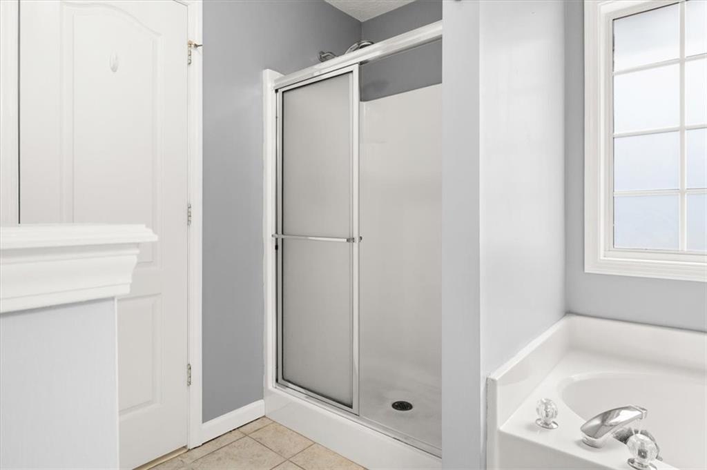1022 Miss Amber Way Locust Grove, GA 30248 - Photo 21 of 43 a bathroom with a shower and a tub