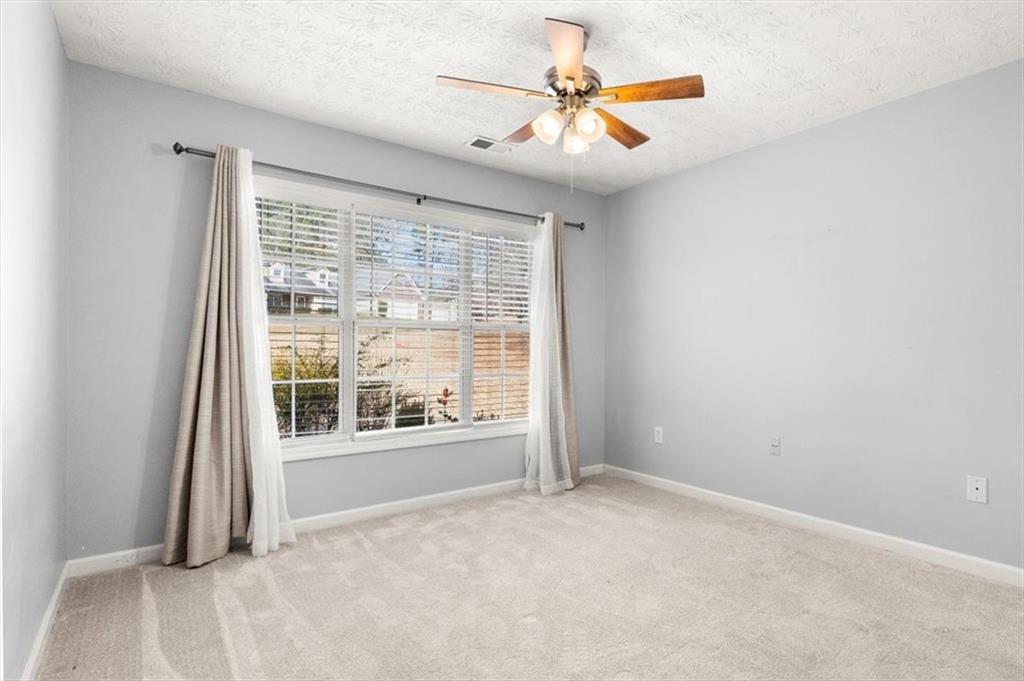 1022 Miss Amber Way Locust Grove, GA 30248 - Photo 22 of 43 a view of an empty room with a window