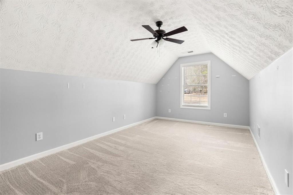 1022 Miss Amber Way Locust Grove, GA 30248 - Photo 27 of 43 a view of a big room with windows and chandelier fan