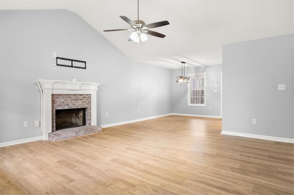 1022 Miss Amber Way Locust Grove, GA 30248 - Photo 3 of 43 a view of empty room with wooden floor and fan