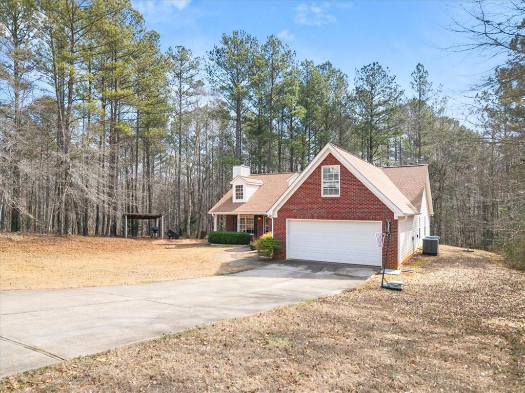 1022 Miss Amber Way Locust Grove, GA 30248 - Photo 34 of 43 a front view of a house with a yard covered in snow