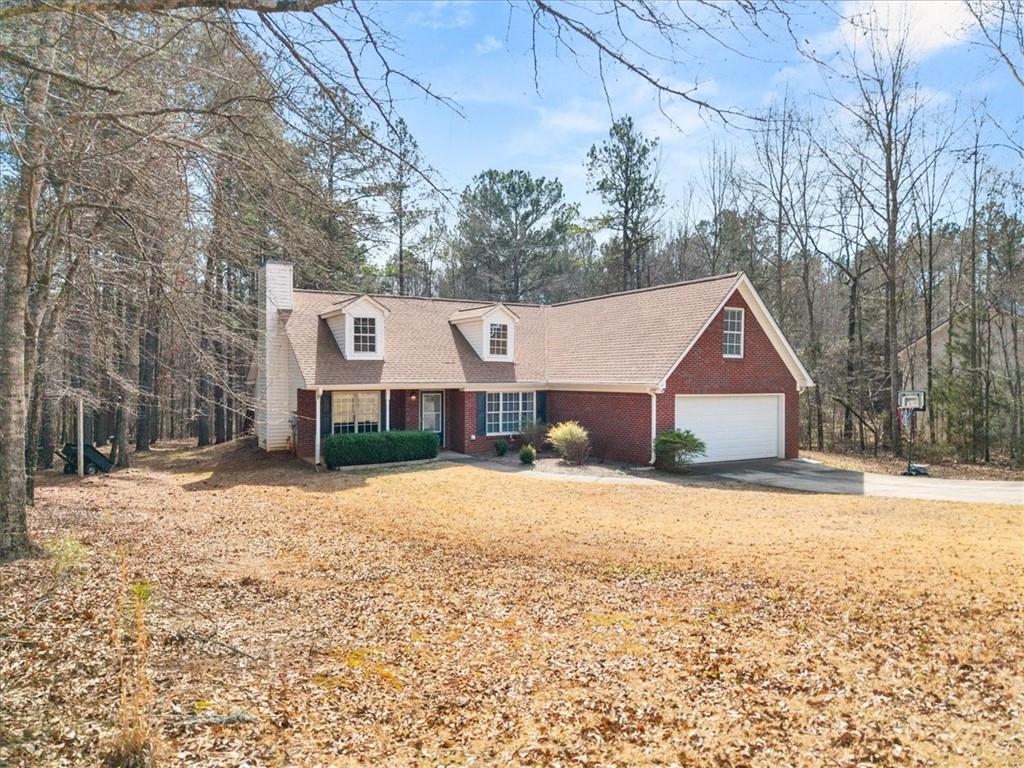 1022 Miss Amber Way Locust Grove, GA 30248 - Photo 35 of 43 a front view of a house with a yard covered in snow