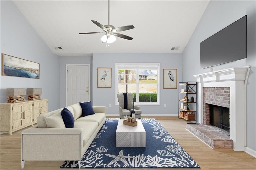 1022 Miss Amber Way Locust Grove, GA 30248 - Photo 4 of 43 a living room with furniture a flat screen tv and a fireplace