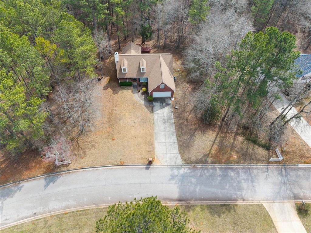 1022 Miss Amber Way Locust Grove, GA 30248 - Photo 43 of 43 an aerial view of a house with a yard and lake view