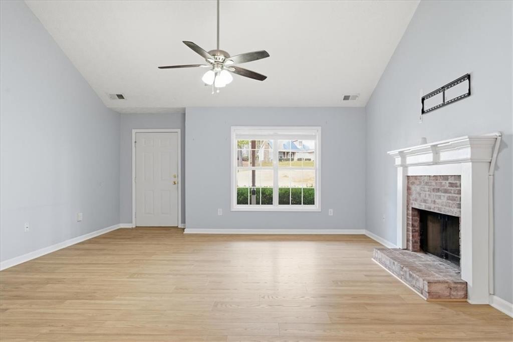 1022 Miss Amber Way Locust Grove, GA 30248 - Photo 5 of 43 a view of an empty room with a window and fireplace