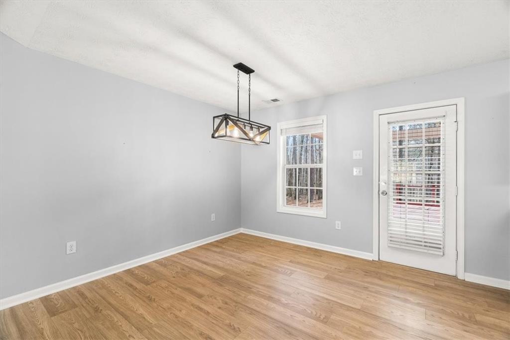 1022 Miss Amber Way Locust Grove, GA 30248 - Photo 7 of 43 wooden floor in an empty room with a window