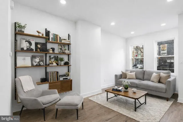 a living room with furniture cabinets and a rug
