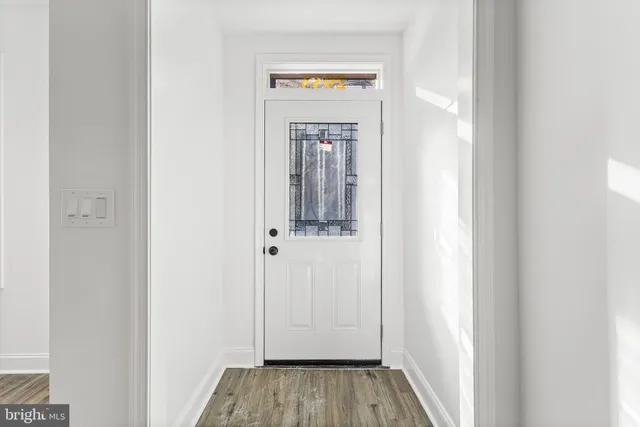 a view of a hallway with wooden floor