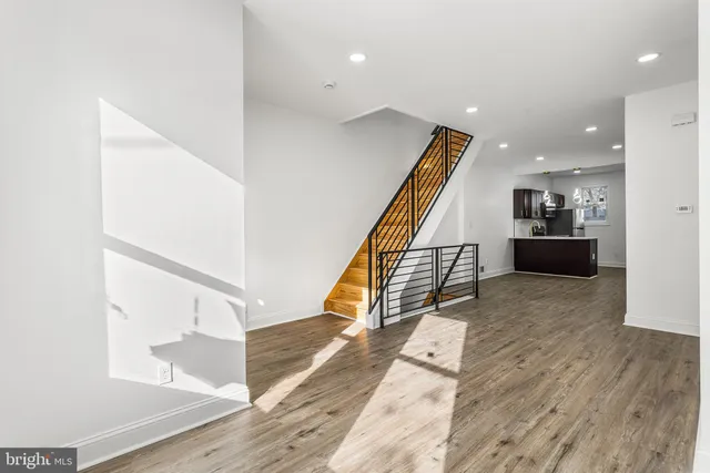 a view of entryway and hall with wooden floor