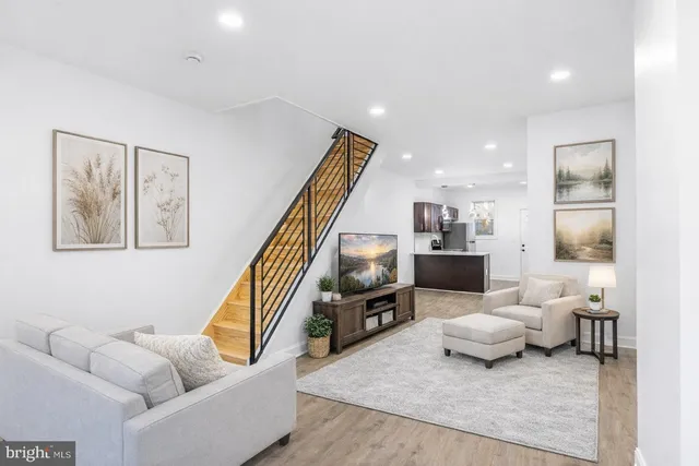 a living room with furniture and a book shelf