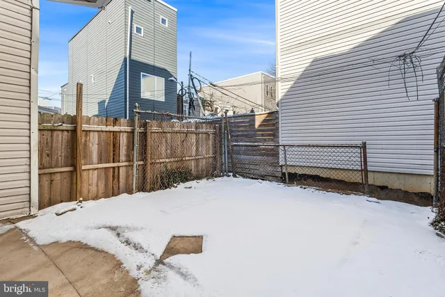 a view of a house with a wooden fence