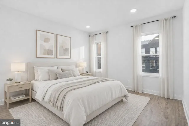 a bedroom with a large bed and a window