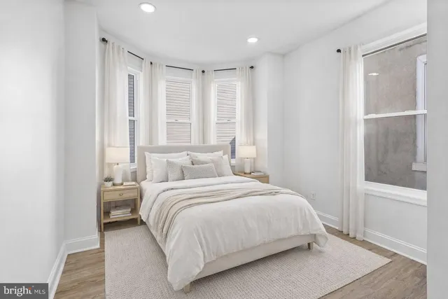 a bedroom with a large bed and a large window