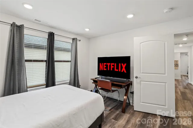 a bedroom with a bed and a flat screen tv