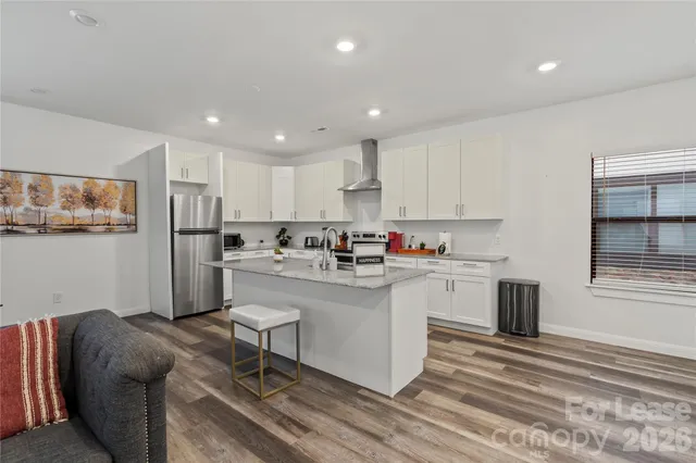 a kitchen with white cabinets and appliances