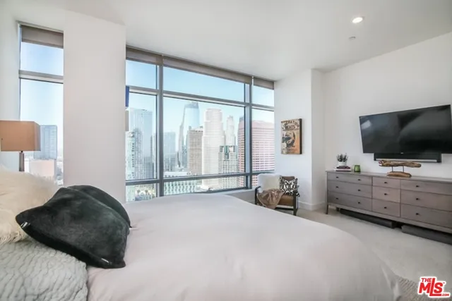 a bedroom with furniture and flat screen tv