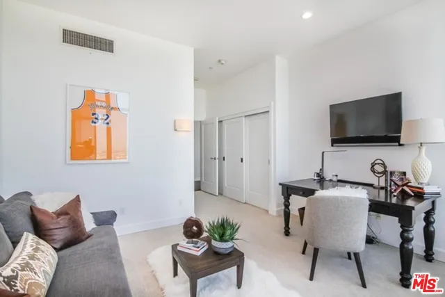 a workspace with furniture and a flat screen tv