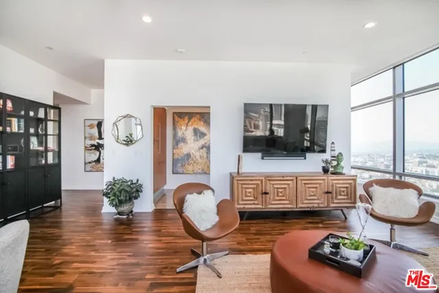 a living room with furniture windows and a flat screen tv